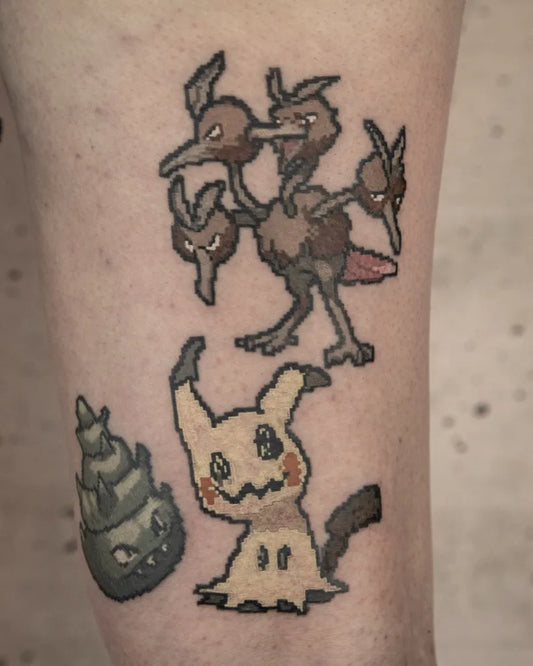 Medium Blackwork Pokemon Mimikyu and Ceruledge Tattoo on Men Leg by @ondaground_uk