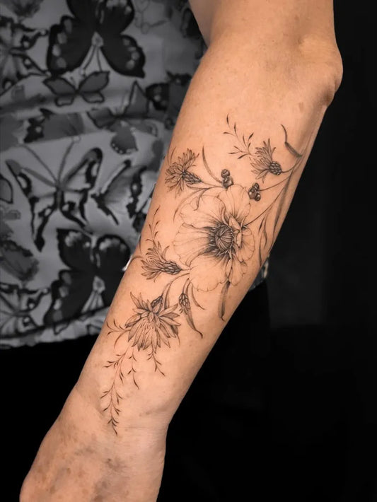 Medium Blackwork Poppy Flowers Tattoo on Women Arm by @nala.ink