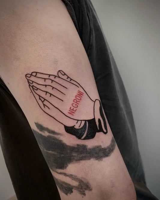 Medium Blackwork Praying Hands with Negro Text Tattoo on Men Arm by @i.want.it.black.tattoo