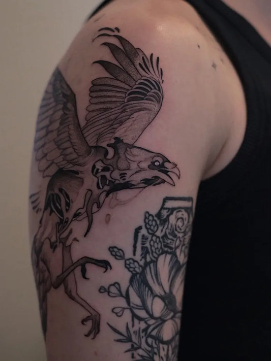 Medium Blackwork Raven with Flowers and Skull on Men Shoulder Tattoo by @finn.j.tattoos