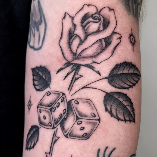 Medium Blackwork Rose and Dice Tattoo on Men Arm by @trewperez