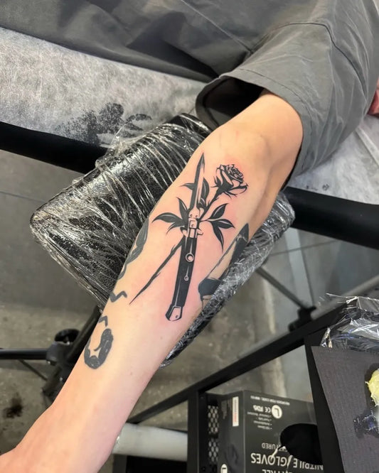 Medium Blackwork Rose and Knife Tattoo on Men Forearm by @zerokid_tattoo