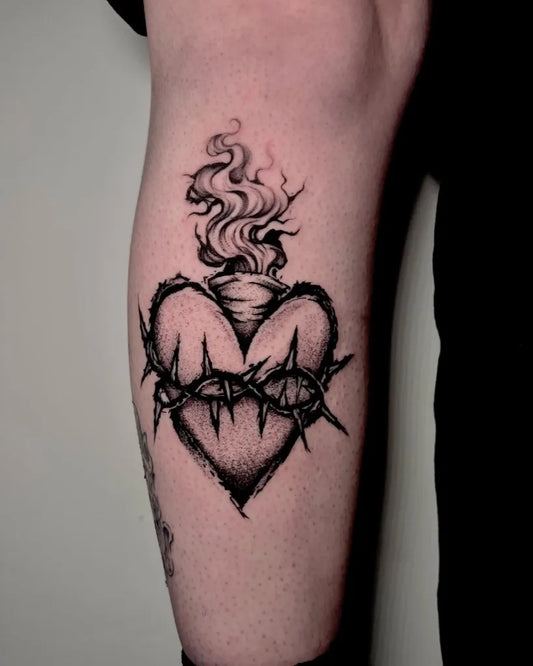 Medium Blackwork Sacred Heart with Barbed Wire and Flames Tattoo on Women Leg by @drunken_dragon_tattoo
