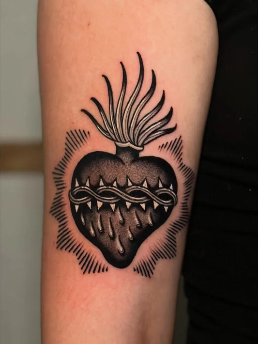 Medium Blackwork Sacred Heart with Crown of Thorns Tattoo on Women Arm by @giuseppe.messina