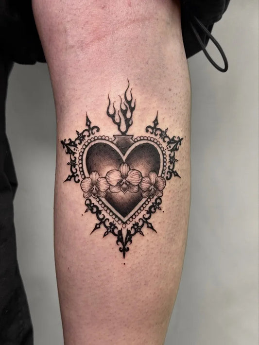 Medium Blackwork Sacred Heart with Flames and Ornament Tattoo on Women Thigh by @sarahs.tatts