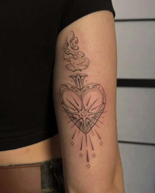 Medium Blackwork Sacred Heart with Flames and Rays Tattoo on Women Upper Arm by @leh.ttt