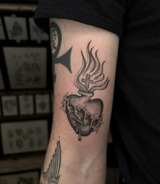 Medium Blackwork Sacred Heart with Flames and Thorns Tattoo on Men Arm by @_billy_blue_tattoo