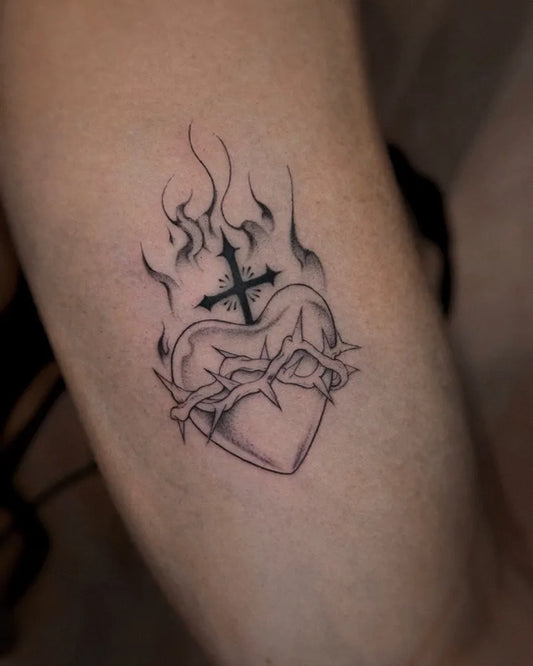 Medium Blackwork Sacred Heart with Flames and Thorns Tattoo on Men Arm by @luminus_inks
