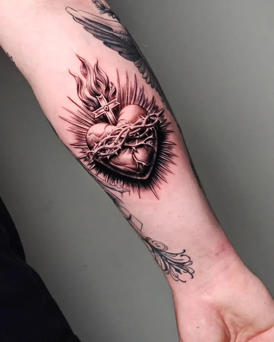 Medium Blackwork Sacred Heart with Flames and Thorns Tattoo on Men Arm by @peternicholson_