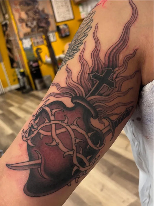 Medium Blackwork Sacred Heart with Flames and Thorns Tattoo on Women Arm by @oinkz_