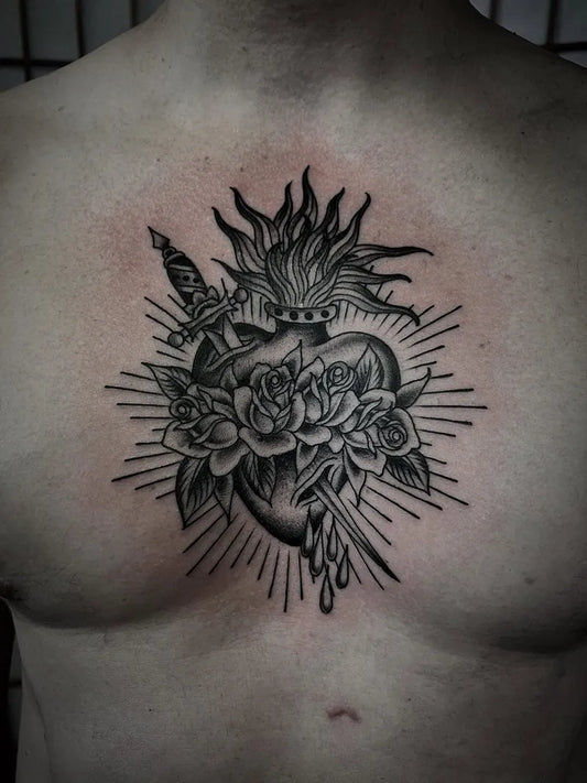 Medium Blackwork Sacred Heart with Roses and Dagger Tattoo on Men Chest by @okayaustinart