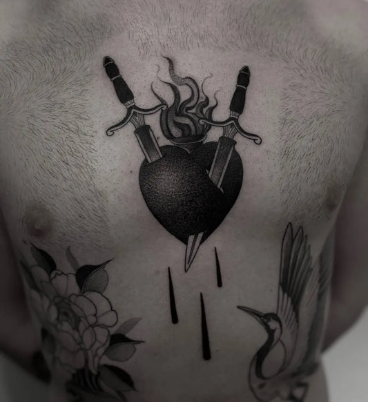 Medium Blackwork Sacred Heart with Swords and Drips Tattoo on Men Chest by @alexplewa_tattoo
