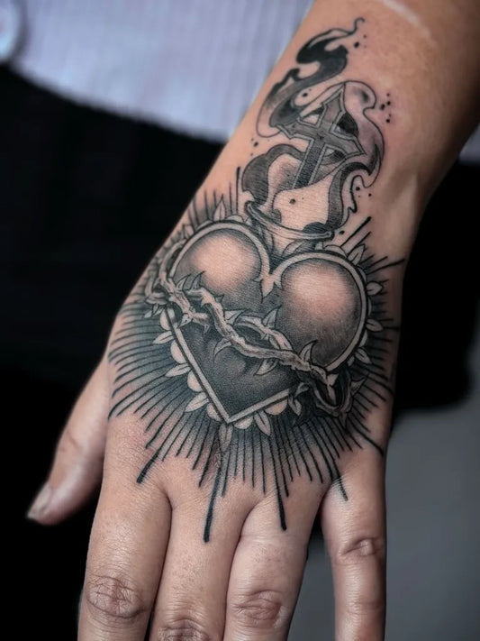 Medium Blackwork Sacred Heart with Thorns and Flames Tattoo on Women Forearm by @kaorukeltattoo