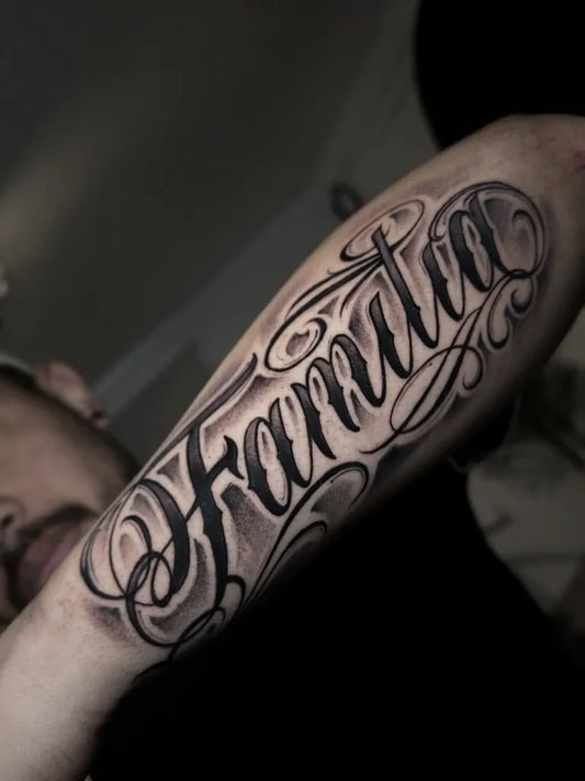 Medium Blackwork Script Family Name Men Arm by @ocre.favela