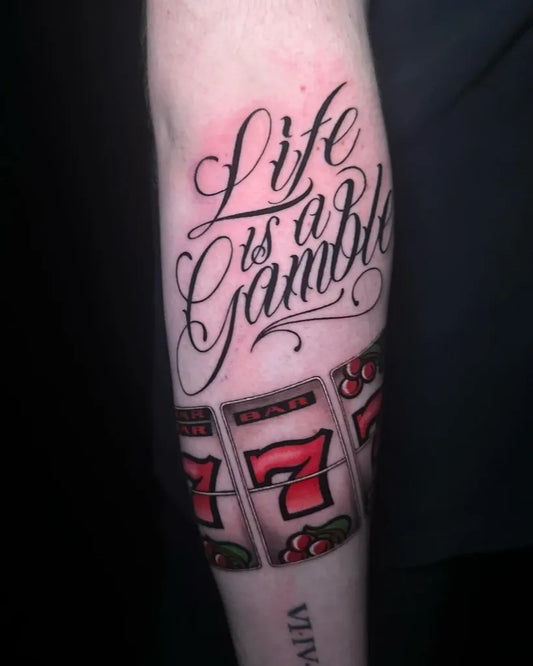 Medium Blackwork Script Life is a Gamble and 777 Slot Machine Tattoo on Men Arm by @lesleyinktattoos
