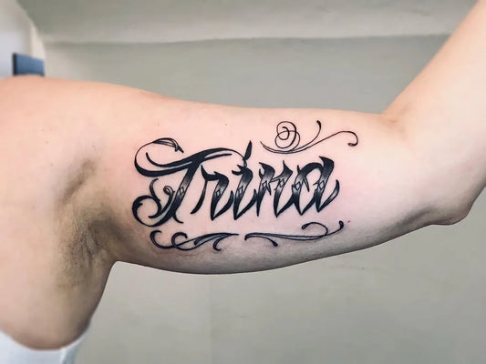 Medium Blackwork Script Name Tattoo on Women Bicep by @atticustattoo