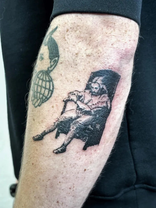 Medium Blackwork Seated Figure and Grenade Tattoo on Men Arm by @noblaztattoo