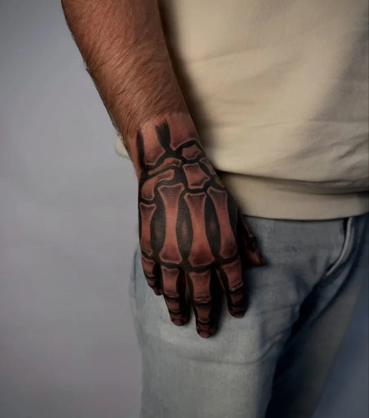 Medium Blackwork Skeleton Hand Tattoo on Men Forearm by @titan.tattoo.store