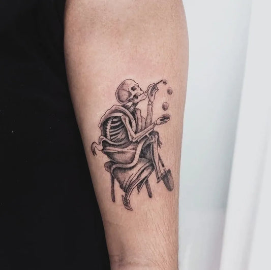Medium Blackwork Skeleton Juggling Tattoo on Men Arm by @covenant.lisboa