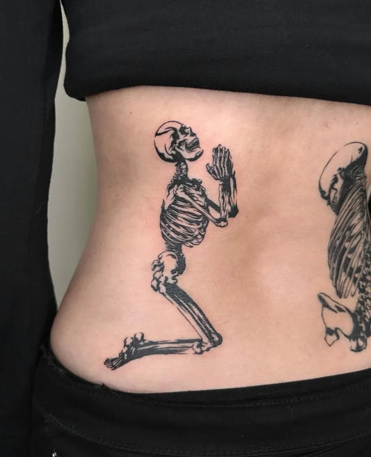 Medium Blackwork Skeleton Praying Tattoo on Women Back by @suzuki.tattoo