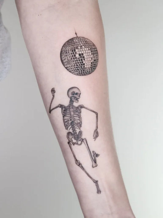 Medium Blackwork Skeleton and Disco Ball Tattoo on Women Arm by @captainshade.tt