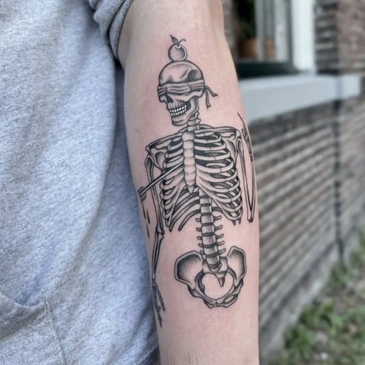 Medium Blackwork Skeleton with Apple and Blindfold Tattoo on Men Arm by @larissa_mitrovic