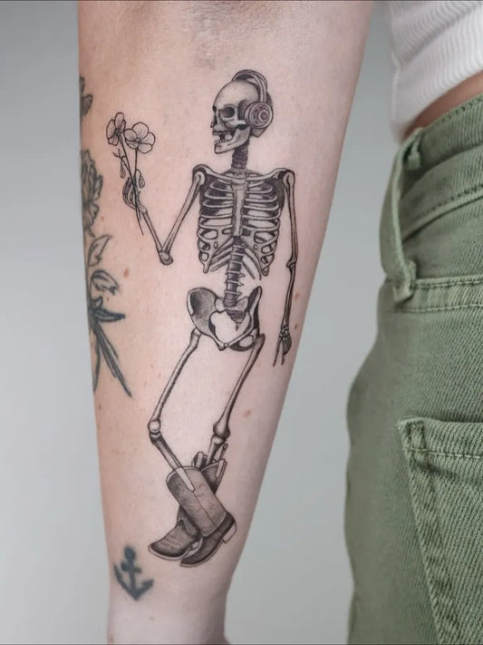 Medium Blackwork Skeleton with Flowers Tattoo on Women Arm by @captainshade.tt