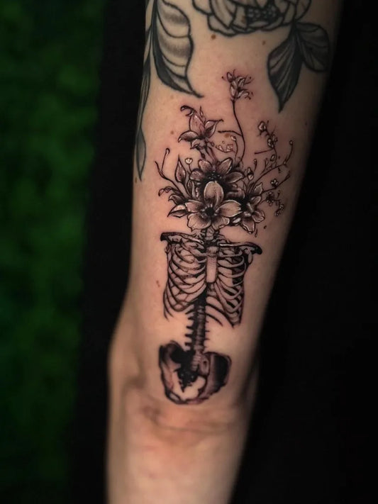 Medium Blackwork Skeleton with Flowers Tattoo on Women Arm by @inkedbysam.paige