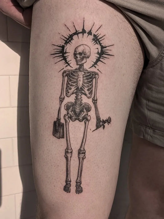 Medium Blackwork Skeleton with Halo and Briefcase Tattoo on Men Thigh by @rhylandmaytatts