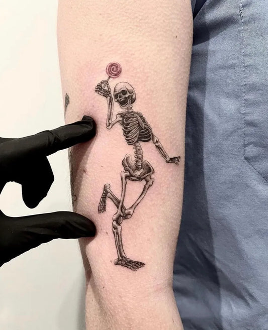 Medium Blackwork Skeleton with Lollipop Tattoo on Men Arm by @thebellrosetattoo