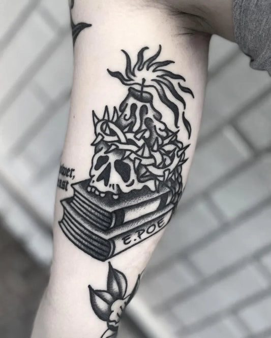 Medium Blackwork Skull Book Tattoo on Women Inner Arm by @jakecortez_tattoos