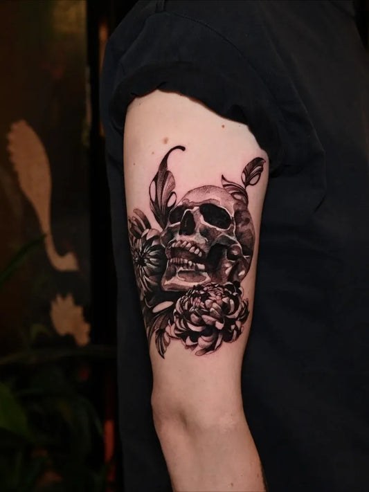 Medium Blackwork Skull Flowers on Women Arm Tattoo by @softchicktattoo