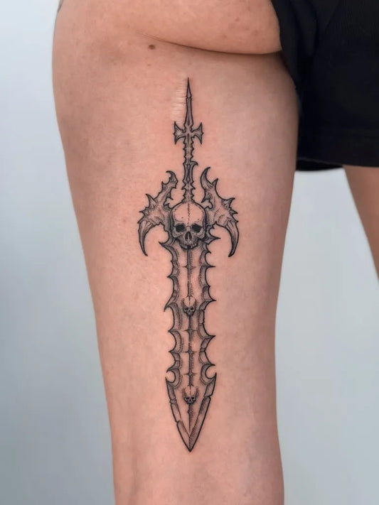 Medium Blackwork Skull Sword on Women Thigh Tattoo by @sad_cid