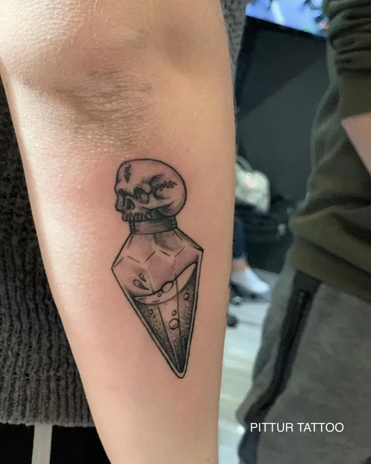 Medium Blackwork Skull Vial on Women Arm Tattoo by @pittur_tattoo
