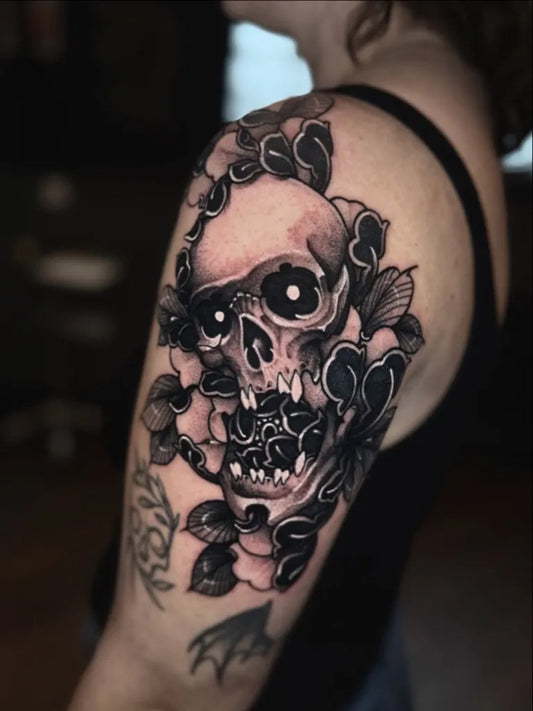 Medium Blackwork Skull and Flowers on Women Arm Tattoo by @zakkbissekertattoo