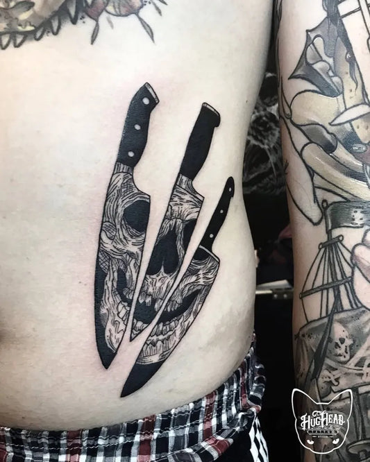 Medium Blackwork Skull and Knives Tattoo on Men Torso by @jjet_black_tattoo