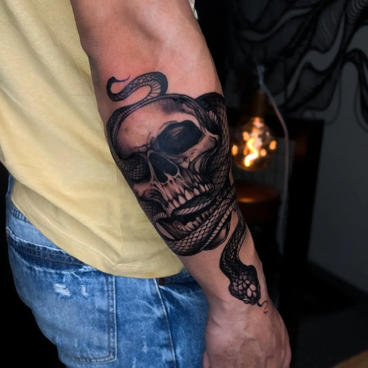 Medium Blackwork Skull and Snake on Men Arm Tattoo by @julio_rochatattoo