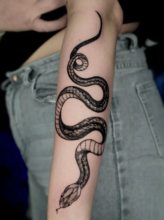 Medium Blackwork Snake Tattoo on Women Arm by @inkeria_tattoo