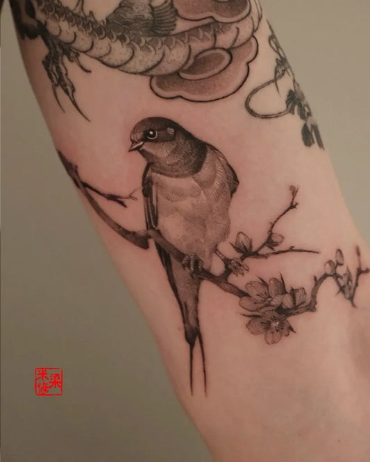 Medium Blackwork Sparrow and Cherry Blossom Tattoo on Women Arm by @michelle.tatts