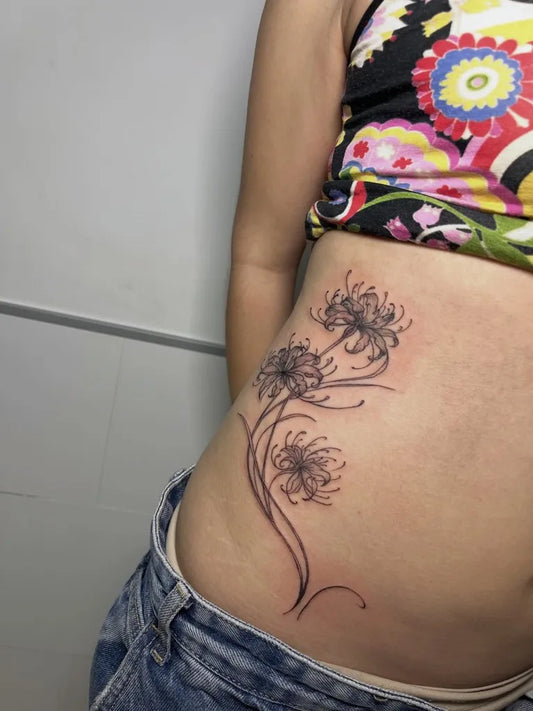 Medium Blackwork Spider Lily Tattoo on Women Hip by @nerai.studio