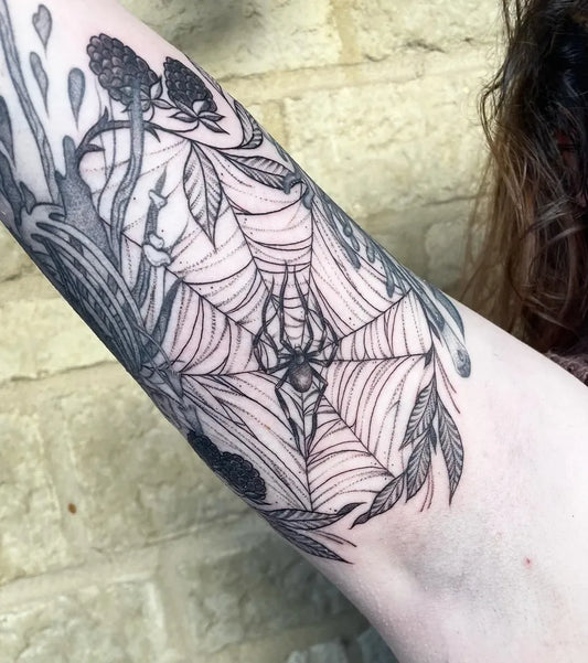 Medium Blackwork Spider Web and Berries Tattoo on Women Inner Arm by @sophiekennedy.tattoos