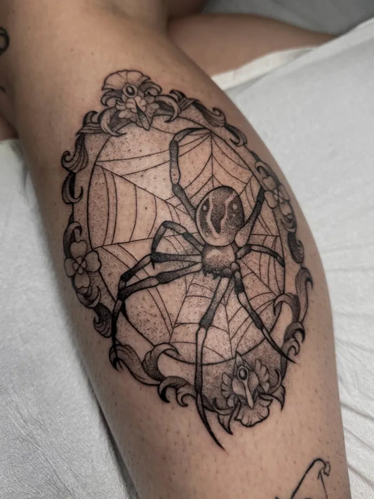 Medium Blackwork Spider Web and Floral Frame on Women Leg Tattoo by @allyghastly