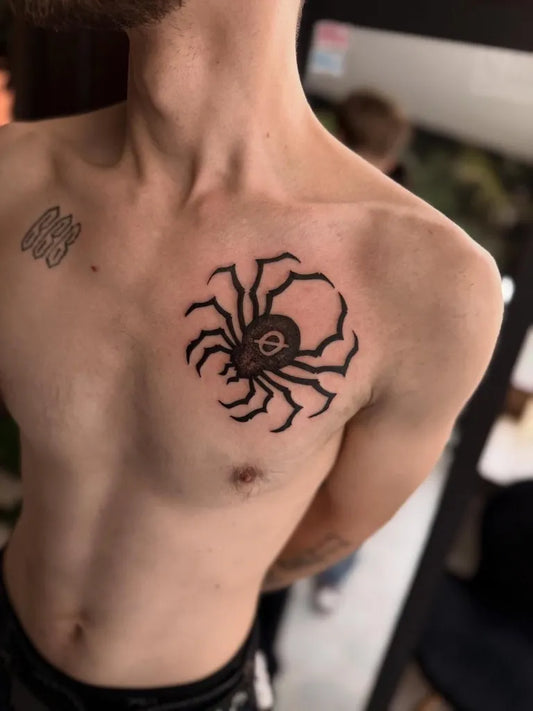 Medium Blackwork Spider on Men Chest Tattoo by @izamajka.tattoo
