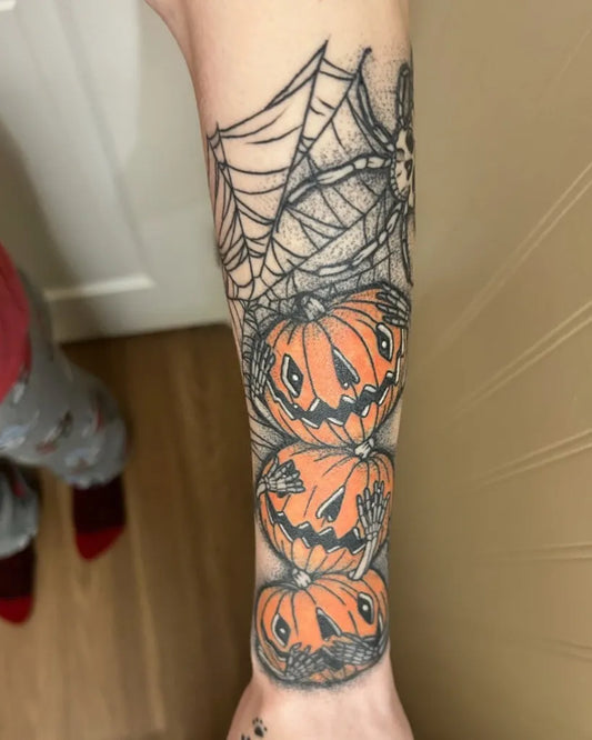 Medium Blackwork Spiderweb Pumpkins Halloween Tattoo on Women Arm by @shelby.inks