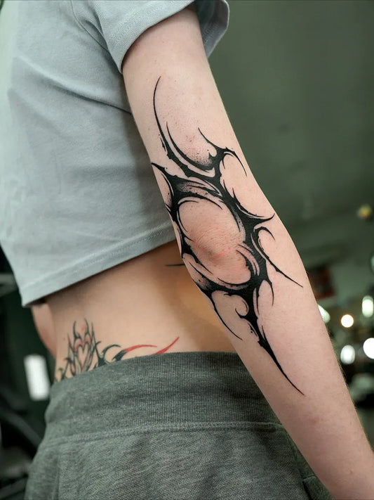 Medium Blackwork Spiky Orb Tattoo on Women Arm by @ziho_tattooer