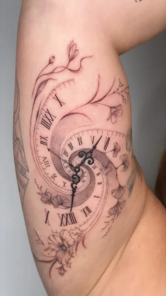 Medium Blackwork Spiral Clock with Flowers Tattoo on Women Arm by @tattoo_berladyn