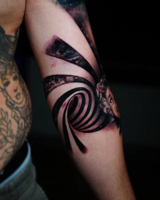 Medium Blackwork Spiral Galaxy and Face Tattoo on Men Inner Arm by @iyanstattoo