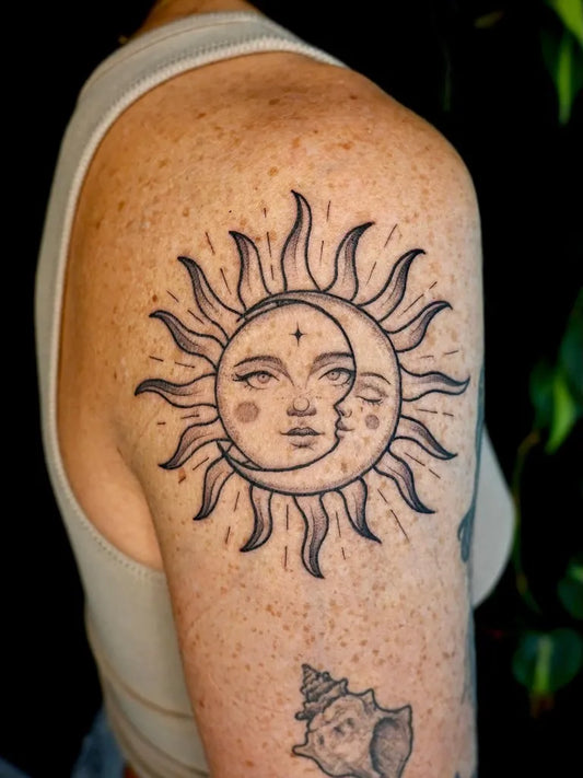 Medium Blackwork Sun Moon Faces on Women Shoulder Tattoo by @felicia.tattoo
