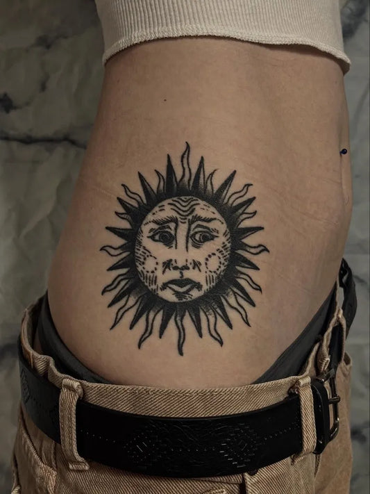 Medium Blackwork Sun Tattoo on Women Side by @ambeartattoos