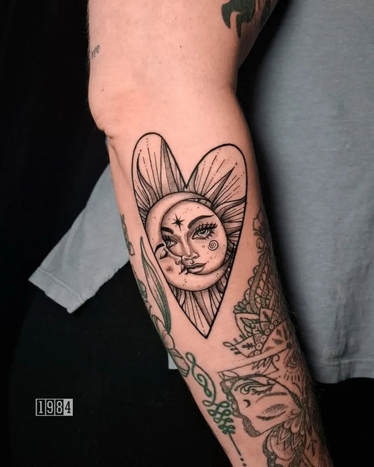 Medium Blackwork Sun and Moon Heart on Women Arm Tattoo by @1984.studios
